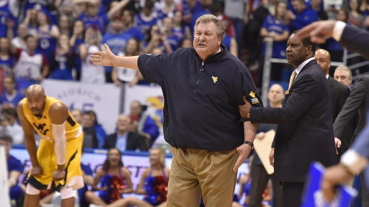 West Virginia guard Jevon Carter (left) watched as his head coach Bob Huggins got ejected from Saturday night’s game at Kansas. KU won, 77-69 at Allen Fieldhouse.