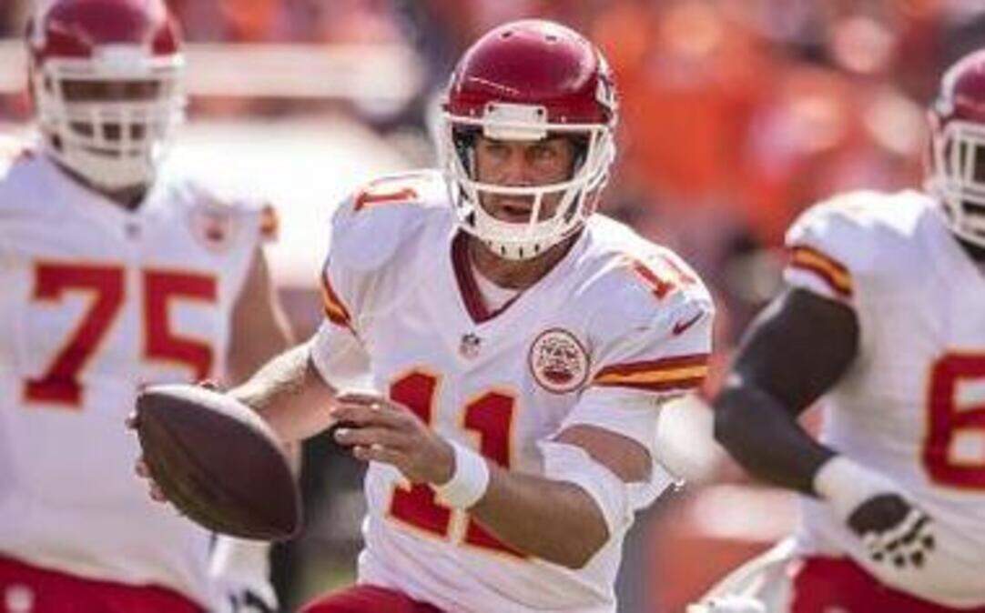 
Kansas City Chiefs quarterback Alex Smith (11) escaped the tackle attempt of Denver Broncos outside linebacker Von Miller (58) in the second quarter on Sept. 14, 2014, at Sports Authority Field at Mile High in Denver. The Chiefs lost 24-17.
