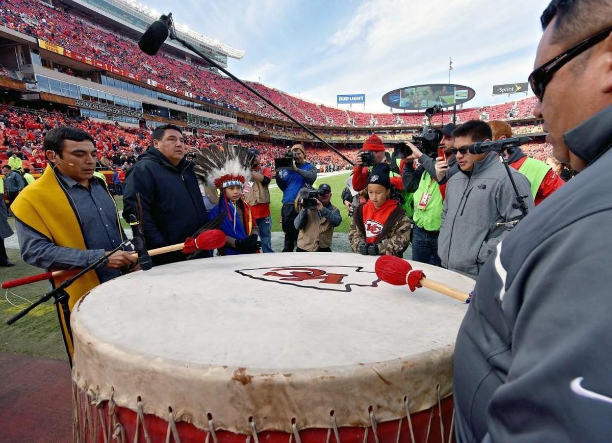 A group of American Indians sing and play the Chiefs’ drum before a game. The team has made it a point of being more inclusive of Native traditions in recent years.