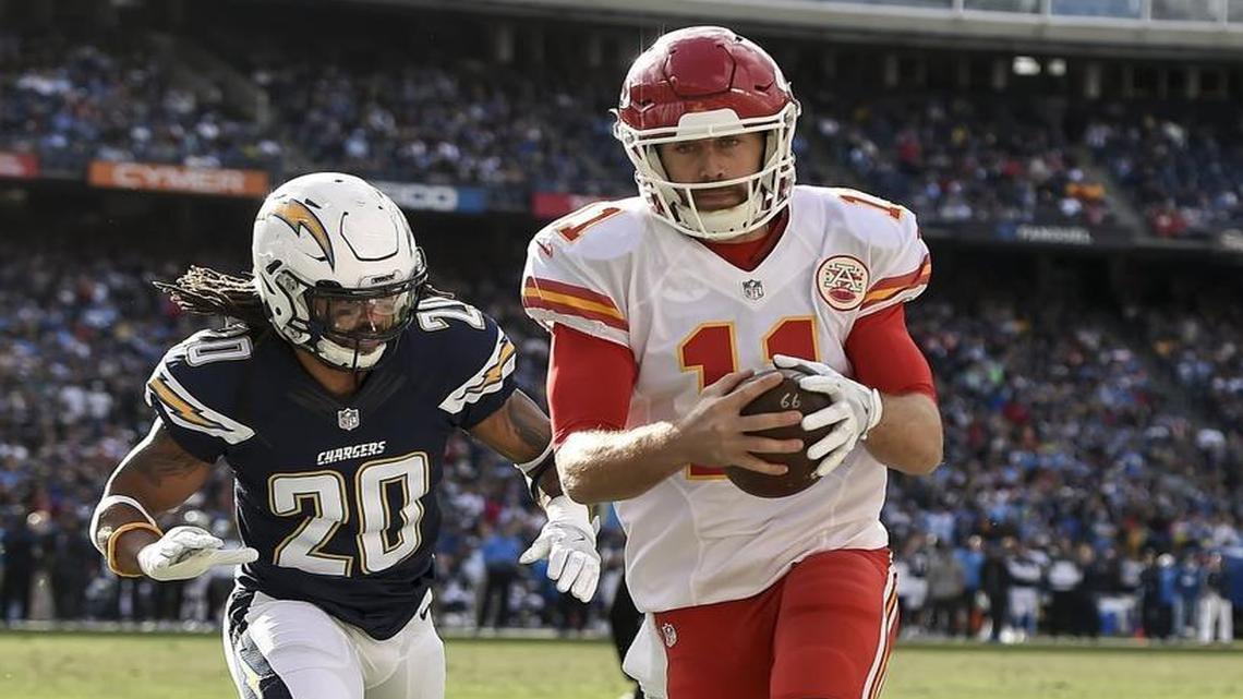 Chiefs quarterback Alex Smith (11) ran for a 5-yard touchdown past Chargers free safety Dwight Lowery (20) in the second quarter on Jan. 1, 2017, at Qualcomm Stadium in San Diego.