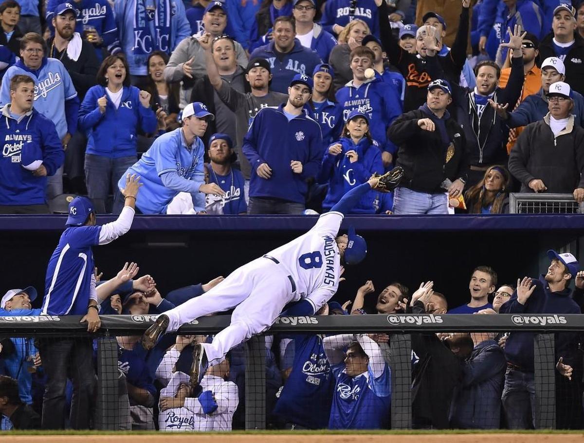It was one of the most iconic images of the Royals’ two-year postseason run, third baseman Mike Moustakas going headlong into the Kauffman Stadium dugout suites to snare a pop-foul and help KC beat Baltimore 2-1 in the 2014 ALCS.