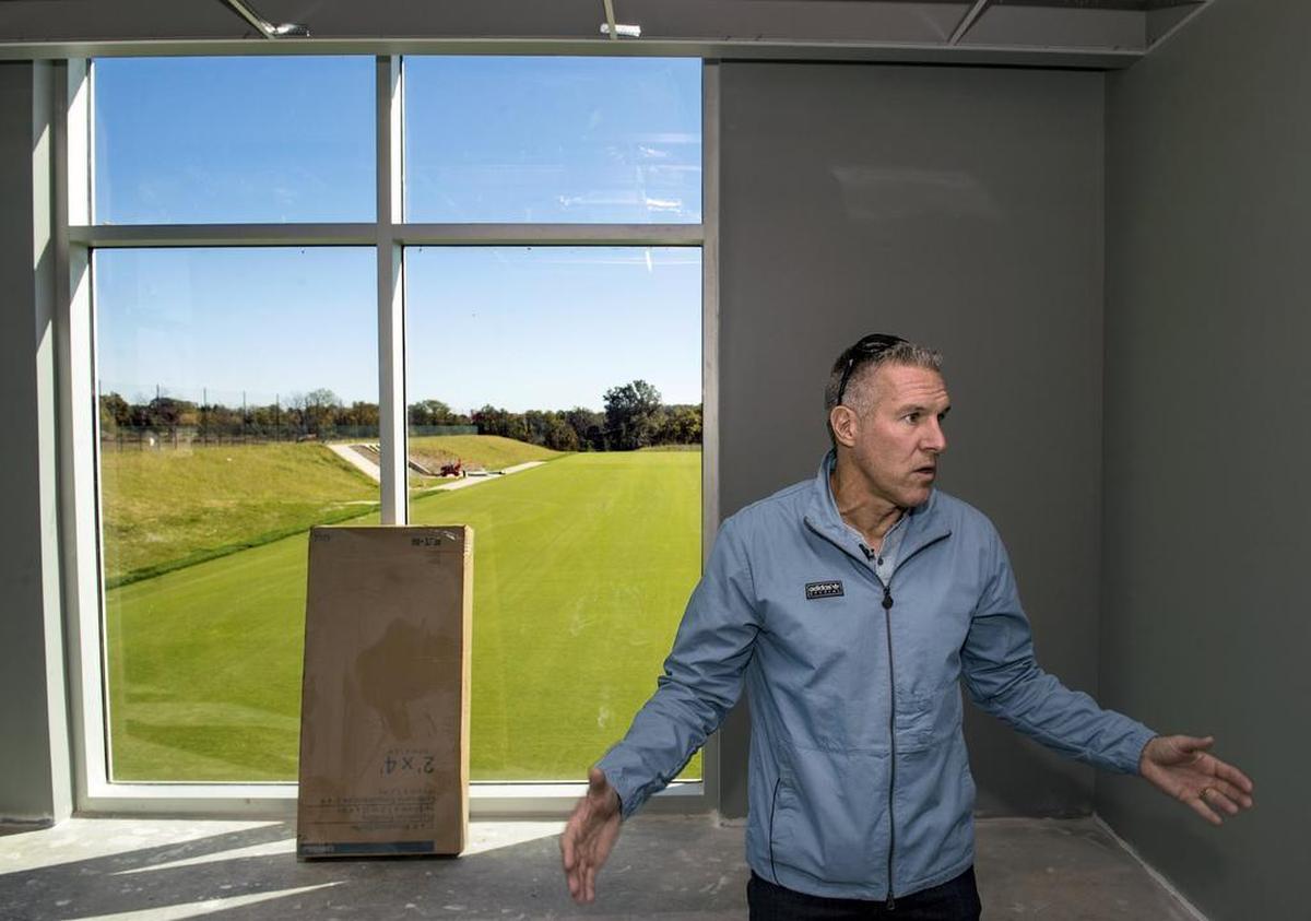 Sporting Kansas City coach Peter Vermes talked in an office space as he gave a tour last month at the National Training and Coaching Development Center in Kansas City, Kan. The $80 million facility, expected to open in December, will provide a permanent home for Sporting Kansas City, a coaching education center for U.S. Soccer and a sports medicine and rehabilitation center.