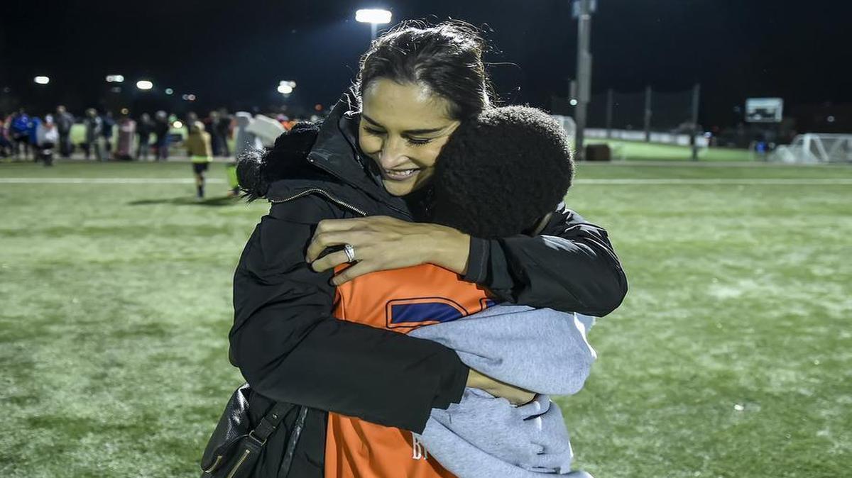 Mariya Dostzadah hugged refugee soccer player Innocent Ngane, 13, from the Congo, after a tournament game on Nov. 11, 2016, at the Overland Park Soccer Complex. Dostzadah, originally from Afghanistan herself, created two refugee and immigrant soccer teams she has organized through the Overland Park Soccer Club and a non-profit, Branch Global.