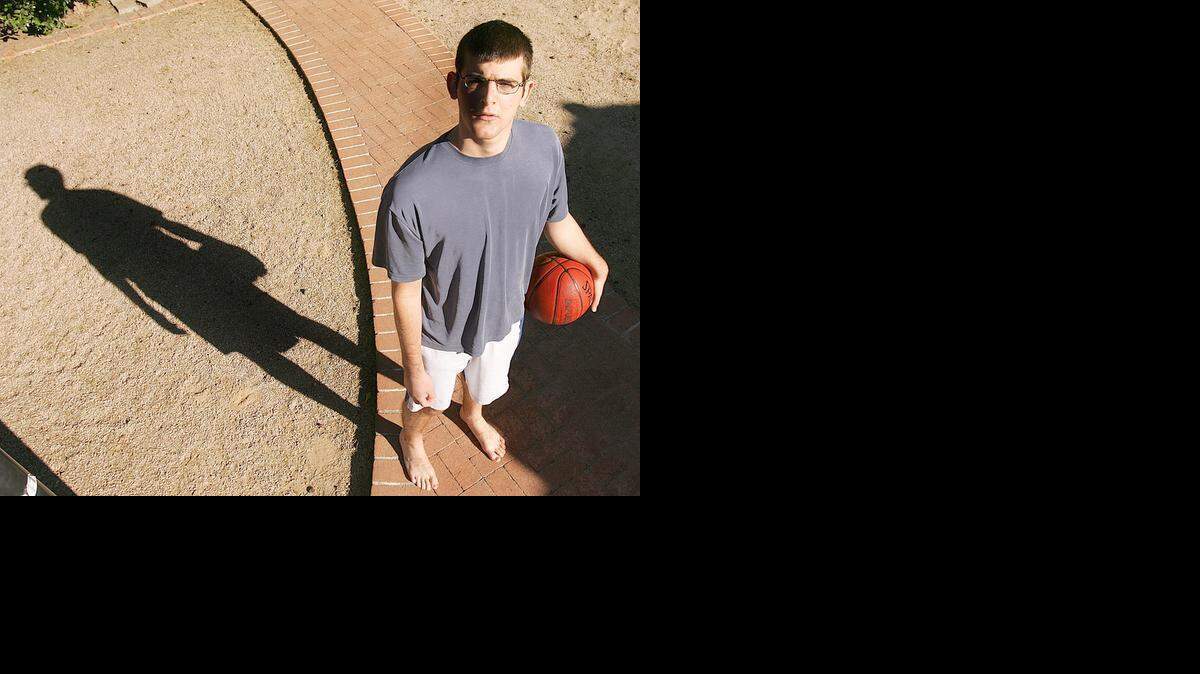 
Joe Kay suffered a stroke that paralyzed the right side of his body after he was caught up in a dogpile of classmates after his team won a close basketball game in 2003. He’s shown here outside his home in 2004.

