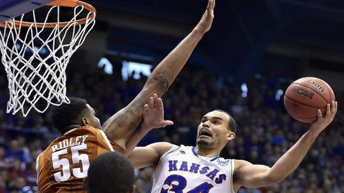 KU's Perry Ellis brushed Texas' Cameron Ridley aside and hit two of his game-high 28 points during the first half of Saturday's game at Allen Fieldhouse, in Lawrence, Kans. KU came from behind to win, 69-64.