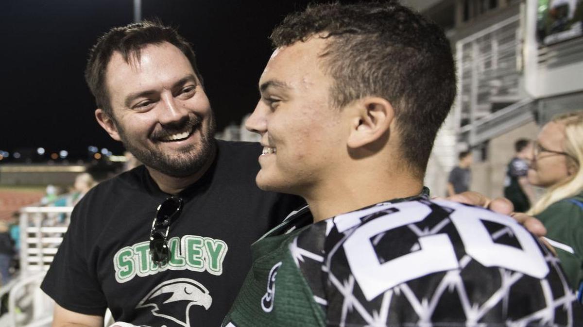 
After Kyle Cambrice got onto the field for the Staley football team on Friday night, he was congratulated by his Big Brother and surrogate dad, Scott Cruce, left.
