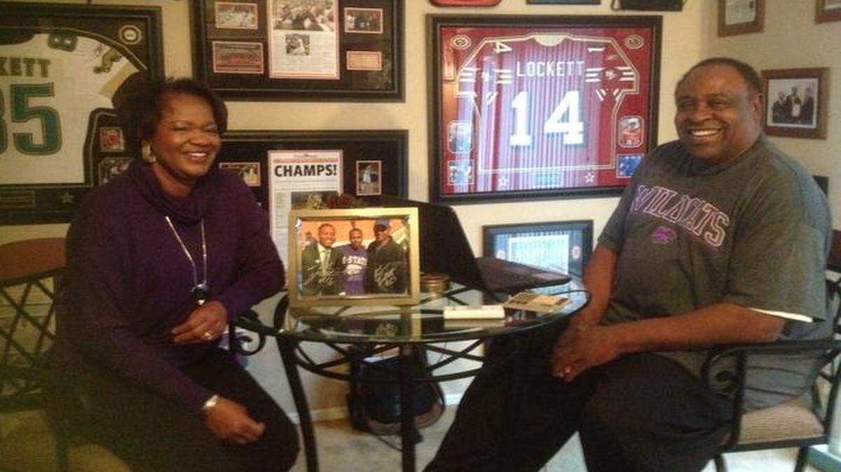 
Beatrice Lockett, left, and her husband John — Kevin’s parents and Tyler’s grandparents — relax in their Tulsa home, which is adorned with mementos of their family’s athletic accomplishments.

