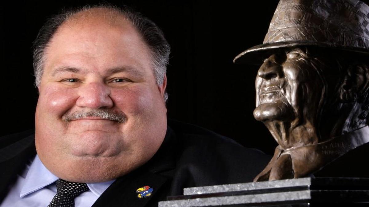 Former Kansas football coach Mark Mangino posed with the Paul “Bear” Bryant College Coach of the Year Award in early 2008.