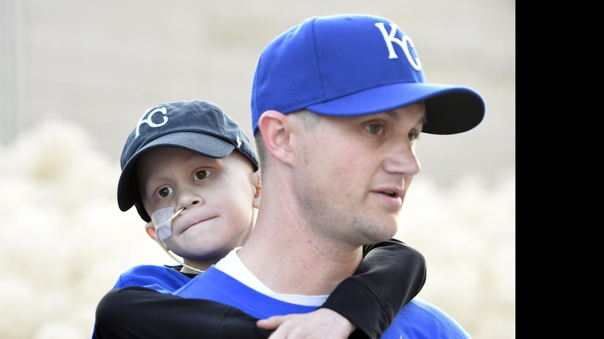 
Six-year-old Noah Wilson clung to his father, Scott Wilson, before game two of the World Series in October. Noah died Tuesday of cancer.
