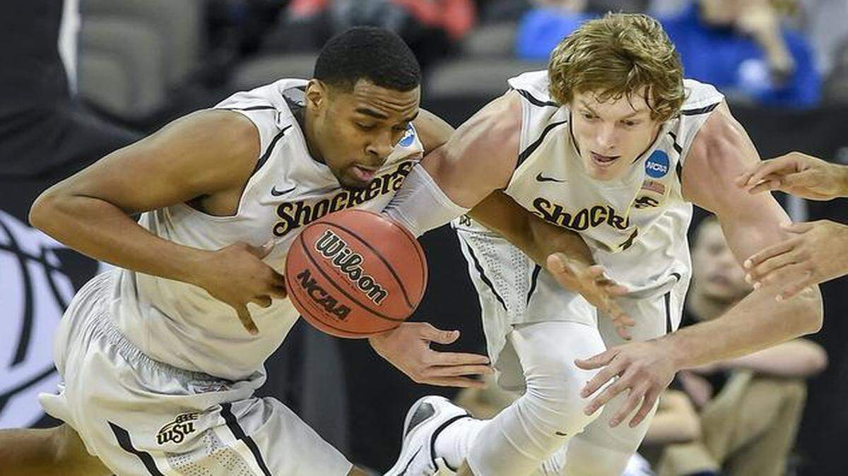
Shockers forward Darius Carter, left, and teammate Ron Baker chase down a loose ball during Wichita State’s win over Indiana on Friday in Omaha.
