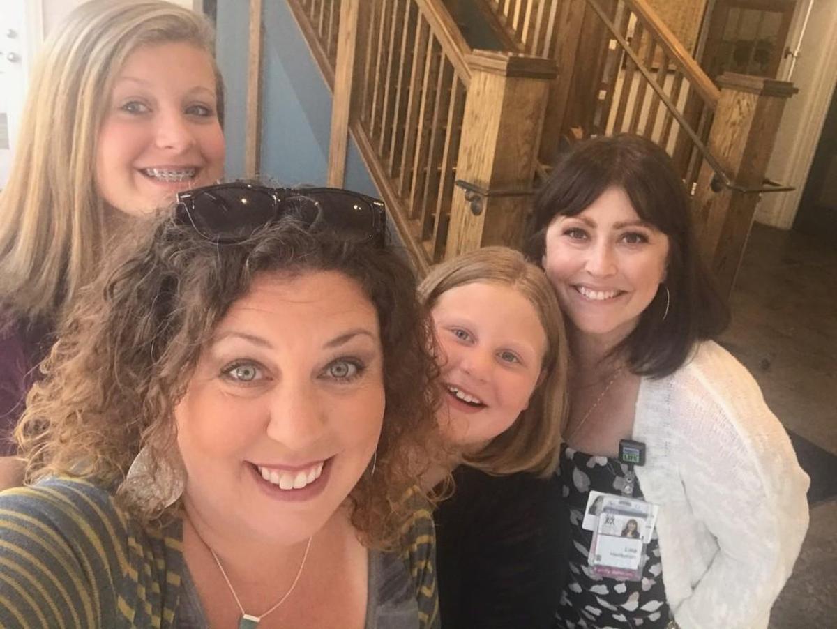 Kari Driskell, at front left with daughters Laurel and Rachel, has come to treasure the support of family services coordinator Lisa Heideman, right.