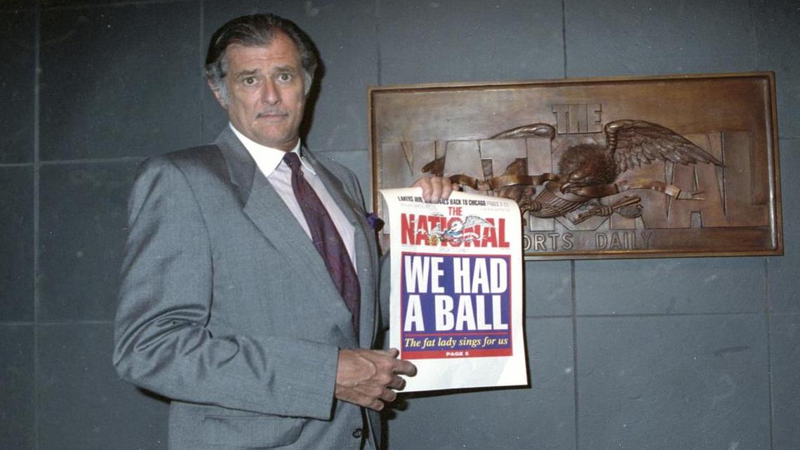 In this June 12, 1991, file photo, Frank Deford, editor and publisher of The National Sports Daily, holds a proof of the final front page of the newspaper after a news conference at the paper’s offices in New York. Deford died Sunday, May 28, 2017, in Key West, Florida, his family confirmed. He was 78.