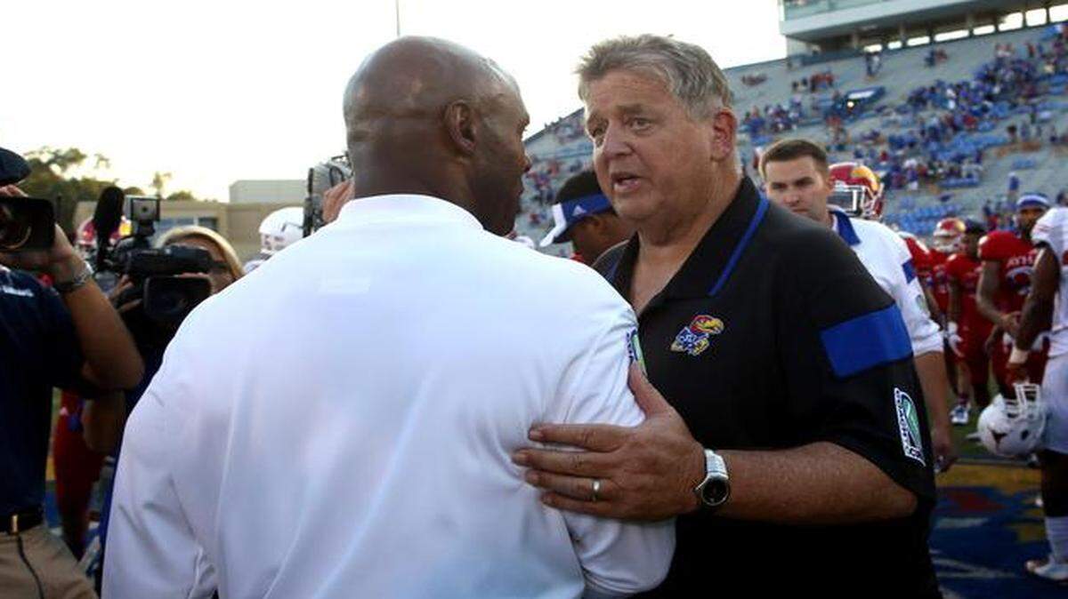 
Texas head coach Charlie Strong (left) and Kansas head coach Charlie Weis might have been commiserating after Saturday’s game at Memorial Stadium in Lawrence.
