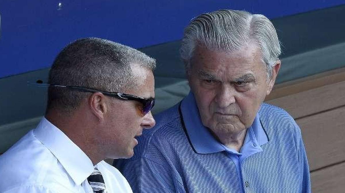 One of the key decisions Royals owner David Glass (right) made was hiring Dayton Moore as general manager.