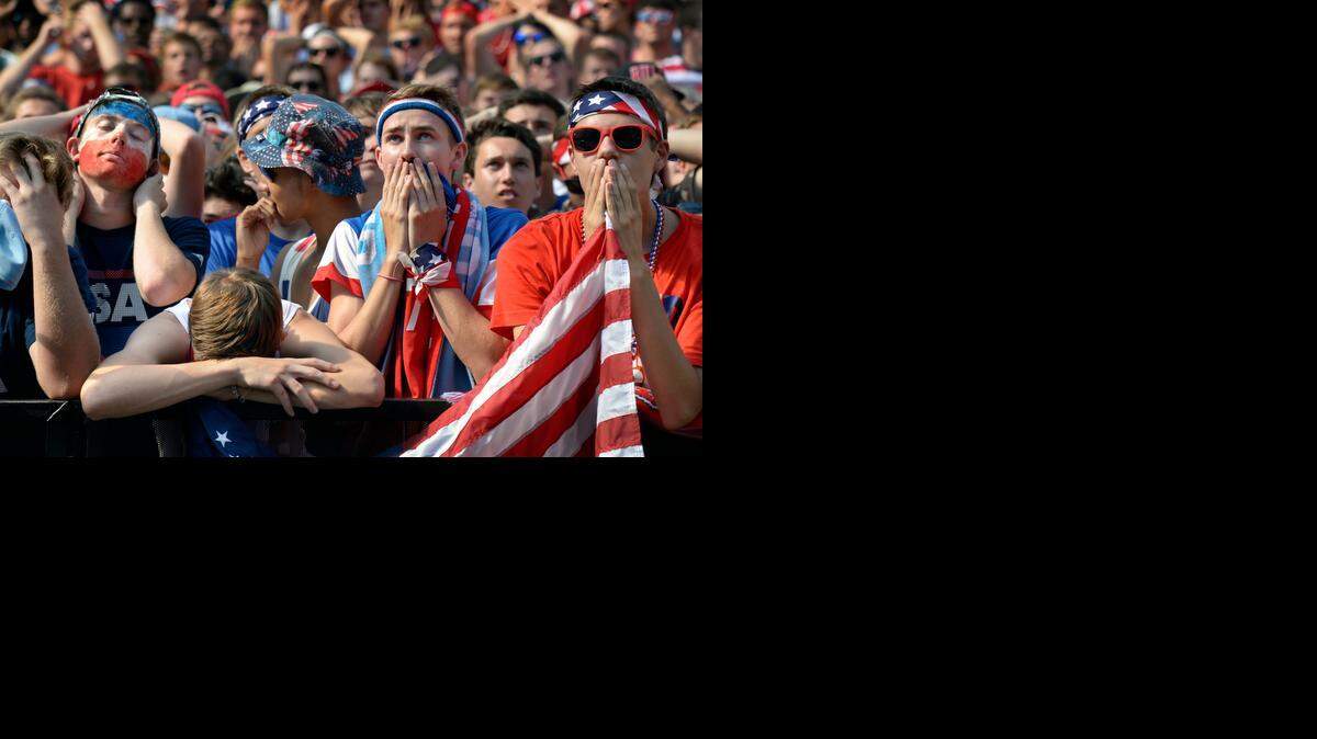 
World Cup soccer fans in the Power & Light District, including A.J. Stephens (left with painted face), Michael Crow (head down on rail), Tyler Samuelson (second from right) and Chandler Stortz, all of Olathe, watched the heartbreaking match Tuesday.
