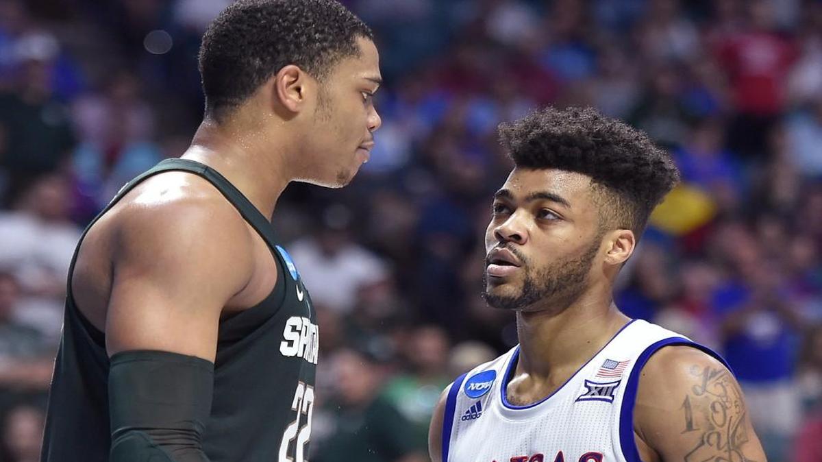 Frank Mason, right, stands his ground after being bumped by Michigan State’s Miles Bridges during Sunday’s NCAA Tournament game in Tulsa.