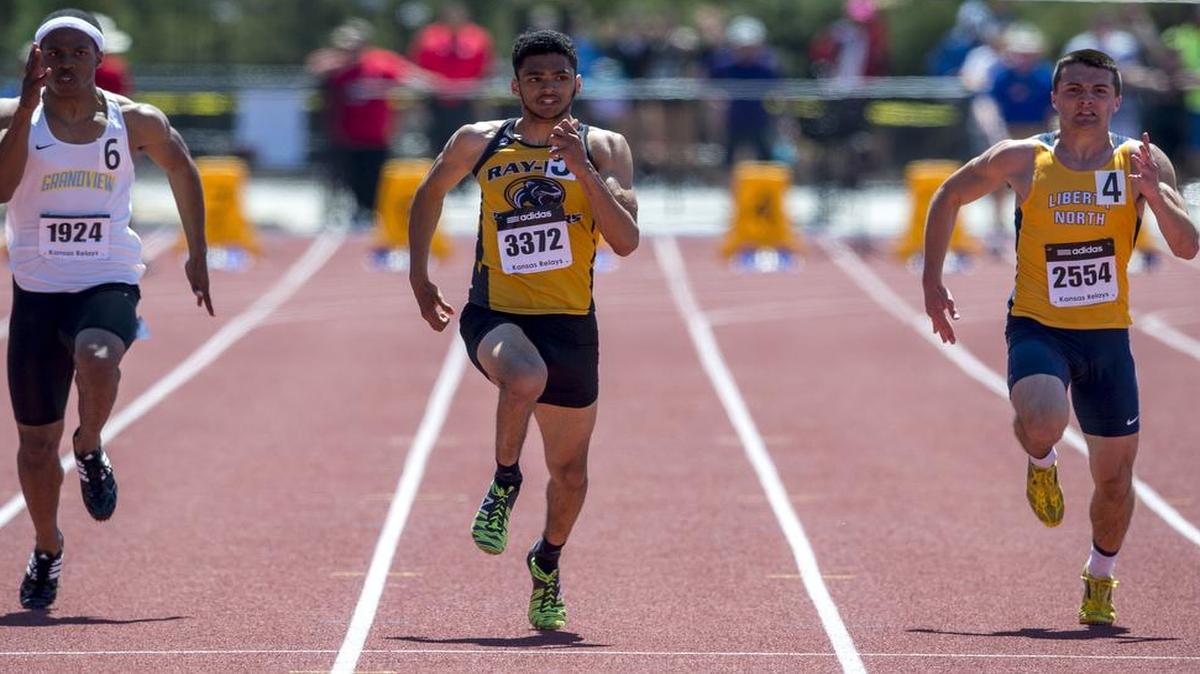 Raymor-Peculiar sprinter Micah Beaver (center) finished ahead of Grandview’s Micah Beaver (left) and Liberty North sprinter Jon Redmond in the 100-meter dash on Saturday at the Kansas Relays. Beaver’s winning time was 10.58 seconds.
