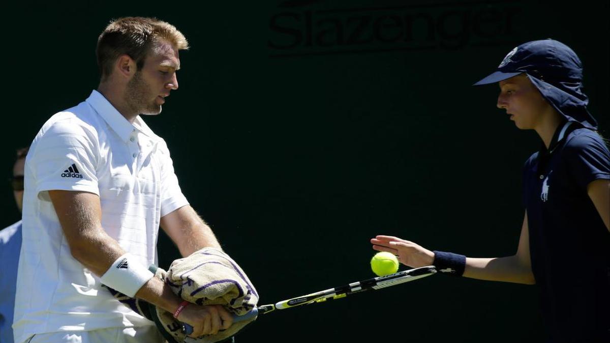 
Jack Sock took a ball from a ball boy during the men's singles first round match against Sam Groth of Australia on Tuesday at the All England Lawn Tennis Championships in Wimbledon, London.
