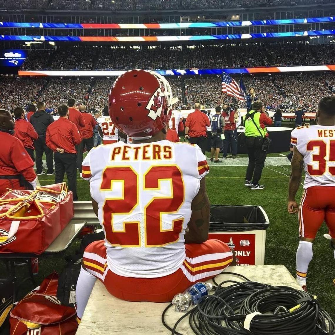 Chiefs cornerback Marcus Peters sat on a trainer’s bench during the national anthem prior to the season opener against the New England Patriots at Gillette Stadium.