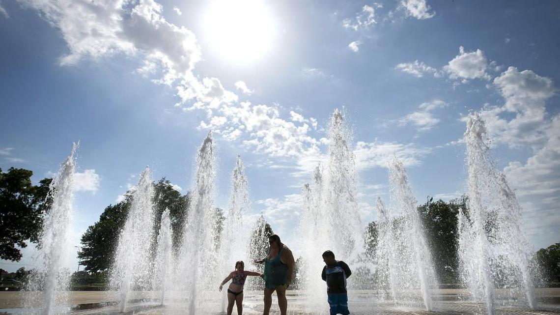 Kayla Lewis, 5, (from left) and her mother, Denise Lewis, of Kansas City, and Abraham Enriquez, 6, of Los Angeles, Calif., enjoy a respite from the heat while splashing in the water on Monday, July 18, 2016, at the Concourse Fountain, located at Benton Boulevard and St. John Avenue in George Kessler Park. The National Weather Service has issued an excessive heat warning for the Kansas City area in effect through 7 p.m. on Friday.